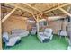 Outdoor living space featuring artificial turf, wood beam frame, and multiple seating options at 54 Del Amo Dr, Las Vegas, NV 89110