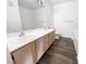 Bathroom features a double sink vanity with white countertops and ample space, with wood-look floors at 5415 W Harmon Ave # 2048, Las Vegas, NV 89103