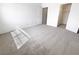 Unfurnished bedroom with neutral carpet, an open closet, and freshly painted white walls at 5415 W Harmon Ave # 2048, Las Vegas, NV 89103