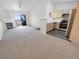 Open-concept living room and kitchen with a fireplace, light colored cabinets and a sliding door to the balcony at 5415 W Harmon Ave # 2048, Las Vegas, NV 89103