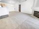 Spacious living room with high ceilings, cozy fireplace, and plush carpeting throughout at 5415 W Harmon Ave # 2048, Las Vegas, NV 89103