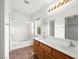 Bright bathroom featuring double sinks, a large mirror, and a shower-tub combo at 6029 Mustang Breeze Trl # 101, Henderson, NV 89011