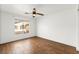 Bright bedroom featuring a ceiling fan and a window with neighborhood views, offering a comfortable retreat at 6029 Mustang Breeze Trl # 101, Henderson, NV 89011