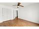 Bright bedroom featuring wood floors, a ceiling fan, and a closet at 6029 Mustang Breeze Trl # 101, Henderson, NV 89011