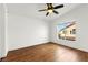 Bright bedroom featuring a ceiling fan and a window with neighborhood views, offering a comfortable retreat at 6029 Mustang Breeze Trl # 101, Henderson, NV 89011