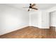 Bright bedroom featuring wood floors, a ceiling fan, and a closet at 6029 Mustang Breeze Trl # 101, Henderson, NV 89011