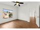 Bright bedroom featuring a ceiling fan and a window with neighborhood views, offering a comfortable retreat at 6029 Mustang Breeze Trl # 101, Henderson, NV 89011