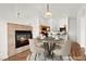 Cozy dining area with a stone fireplace and an adjacent kitchen offering both style and functionality at 6029 Mustang Breeze Trl # 101, Henderson, NV 89011
