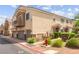 Attractive townhome showcasing a three-car garage and well-maintained landscaping at 6029 Mustang Breeze Trl # 101, Henderson, NV 89011