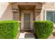Welcoming front entrance framed by manicured greenery, providing a serene approach at 6029 Mustang Breeze Trl # 101, Henderson, NV 89011