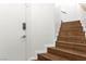 Wooden staircase leading to the upper level, complemented by white walls at 6029 Mustang Breeze Trl # 101, Henderson, NV 89011