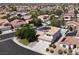 Wide aerial perspective capturing a residential neighborhood with homes featuring pools and solar panels at 6313 Giant Oak St, North Las Vegas, NV 89084
