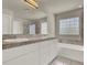 Bathroom featuring a double sink vanity with tile flooring and a glass block window at 6313 Giant Oak St, North Las Vegas, NV 89084