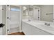 Bathroom featuring double sinks, white cabinets, a bathtub, and tile floors at 6313 Giant Oak St, North Las Vegas, NV 89084