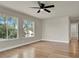 Bedroom with wood floors, a ceiling fan, and windows bringing in sunlight at 6313 Giant Oak St, North Las Vegas, NV 89084