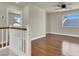 Bright bedroom with hardwood floors, ceiling fan, and a window showcasing outdoor light at 6313 Giant Oak St, North Las Vegas, NV 89084