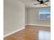 Bedroom with ceiling fan and natural light illuminating hardwood floors at 6313 Giant Oak St, North Las Vegas, NV 89084