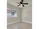 Bedroom with a ceiling fan, a window offering natural light and tile flooring at 6313 Giant Oak St, North Las Vegas, NV 89084