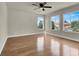 Bedroom with wood floors, a ceiling fan, and bright, sunny windows at 6313 Giant Oak St, North Las Vegas, NV 89084