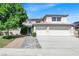 Charming two-story home with a well-manicured lawn and a spacious three-car garage and welcoming walkway at 6313 Giant Oak St, North Las Vegas, NV 89084