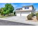 Attractive exterior view of home with large driveway, beautiful landscaping, and a well-maintained lawn at 6313 Giant Oak St, North Las Vegas, NV 89084