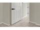 Hallway with beige tile flooring, a white door, and tan walls at 6313 Giant Oak St, North Las Vegas, NV 89084
