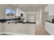 Modern kitchen featuring white cabinets, dark countertops, and tile flooring at 6313 Giant Oak St, North Las Vegas, NV 89084