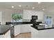 Stylish kitchen with white cabinets, granite countertops, and stainless steel appliances at 6313 Giant Oak St, North Las Vegas, NV 89084