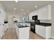 Modern kitchen with an island and white cabinets and view into the open living room at 6313 Giant Oak St, North Las Vegas, NV 89084