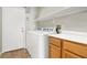 Well-equipped laundry room with shelving, storage and modern white appliances at 6313 Giant Oak St, North Las Vegas, NV 89084