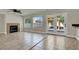 Cozy living room featuring a fireplace, tile flooring, and backyard access through French doors at 6313 Giant Oak St, North Las Vegas, NV 89084