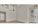 Bright living room with soaring ceilings, chandelier, and neutral color palette at 6313 Giant Oak St, North Las Vegas, NV 89084