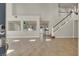 Open-concept living room with tile floors, bright natural light, and staircase at 6313 Giant Oak St, North Las Vegas, NV 89084