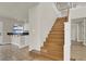 Open staircase with hardwood steps, a white bannister and access to the kitchen at 6313 Giant Oak St, North Las Vegas, NV 89084