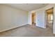 Simple bedroom with neutral carpeting, a closet, and a doorway, offering a clean and customizable space at 6381 Pronghorn Ridge Ave, Las Vegas, NV 89122