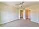 Comfortable bedroom featuring neutral carpeting, a ceiling fan, and ample closet space for storage solutions at 6381 Pronghorn Ridge Ave, Las Vegas, NV 89122