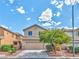 Charming two-story home featuring a well-manicured front yard with lush green landscaping and a spacious two-car garage at 6381 Pronghorn Ridge Ave, Las Vegas, NV 89122