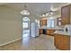 Cozy kitchen features tile floors, appliances, wood cabinets, and an open layout into the living area at 6381 Pronghorn Ridge Ave, Las Vegas, NV 89122