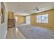 Spacious living room featuring neutral carpeting, a ceiling fan, staircase, and natural light streaming through large windows at 6381 Pronghorn Ridge Ave, Las Vegas, NV 89122