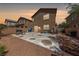 Spacious backyard with gravel landscaping, brick wall, and a concrete patio perfect for outdoor entertaining at 6409 Dundock Ave, Las Vegas, NV 89122