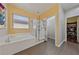 Bathroom featuring a soaking tub, glass shower, and separate access to a closet at 6409 Dundock Ave, Las Vegas, NV 89122