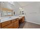 Bright bathroom with dual sinks, wood cabinets, and a separate shower at 6409 Dundock Ave, Las Vegas, NV 89122