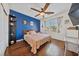 Cozy bedroom with wood floors, natural light and a contrasting wall at 6409 Dundock Ave, Las Vegas, NV 89122