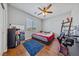 Comfortable bedroom features hardwood floors and a ceiling fan at 6409 Dundock Ave, Las Vegas, NV 89122