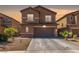 Two-story home featuring a two car garage, desert landscaping and an attractive exterior at 6409 Dundock Ave, Las Vegas, NV 89122