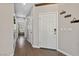 Inviting hallway with wood-style tile flooring and decor leading to other rooms at 6409 Dundock Ave, Las Vegas, NV 89122