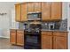 Well-equipped kitchen with modern appliances, granite countertops, and maple cabinets at 6409 Dundock Ave, Las Vegas, NV 89122