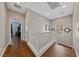 Spacious landing area featuring wood floors, white railings, and natural light at 6409 Dundock Ave, Las Vegas, NV 89122