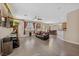 Open-concept living room boasts tile floors, ample natural light, and seamless flow into the dining area at 6409 Dundock Ave, Las Vegas, NV 89122