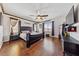 Large main bedroom with hardwood floors and a ceiling fan offering natural light at 6409 Dundock Ave, Las Vegas, NV 89122